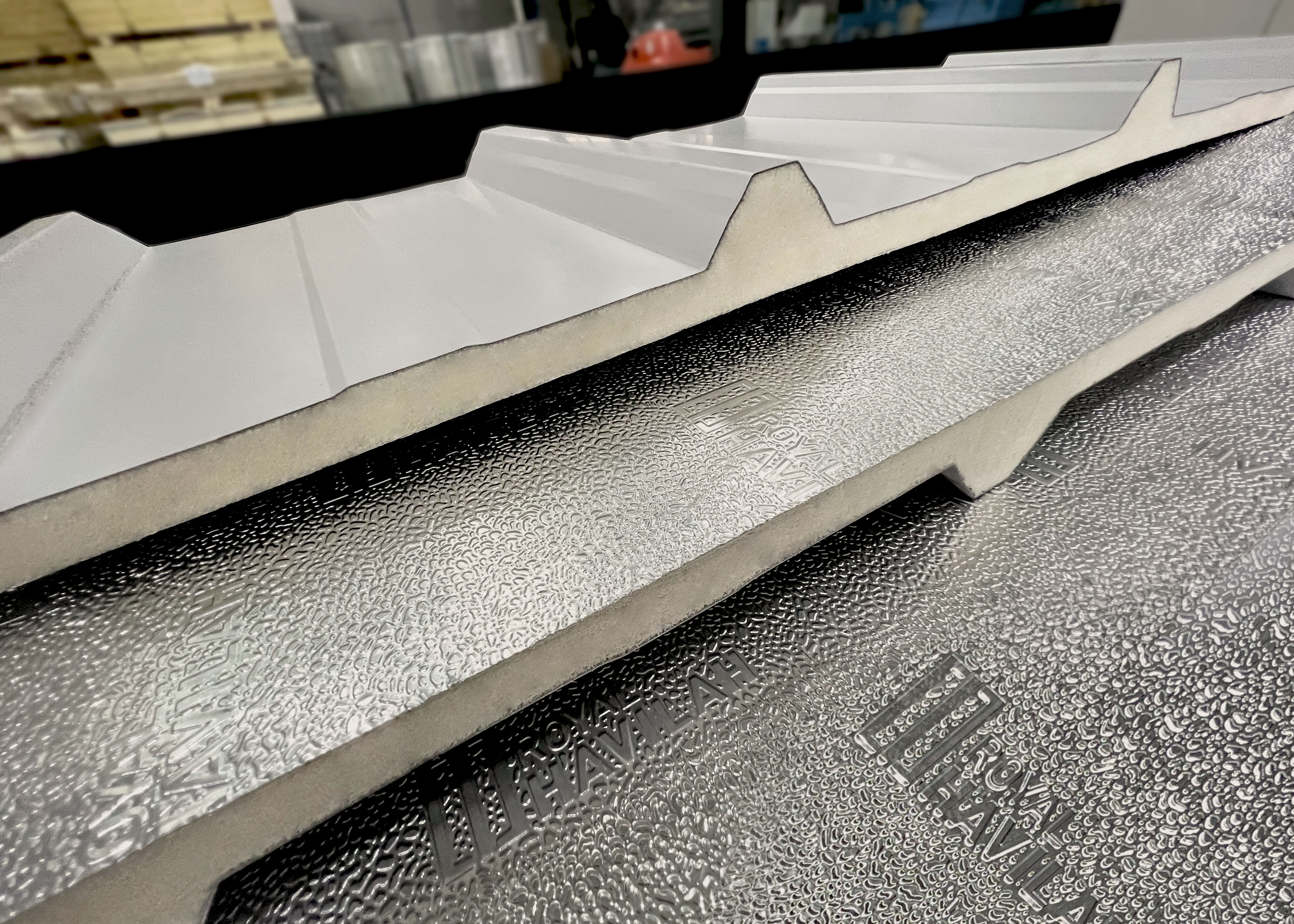 Royal Roof PIR aluminium panel close-up showing trapezoidal metal top skin and embossed foil underside