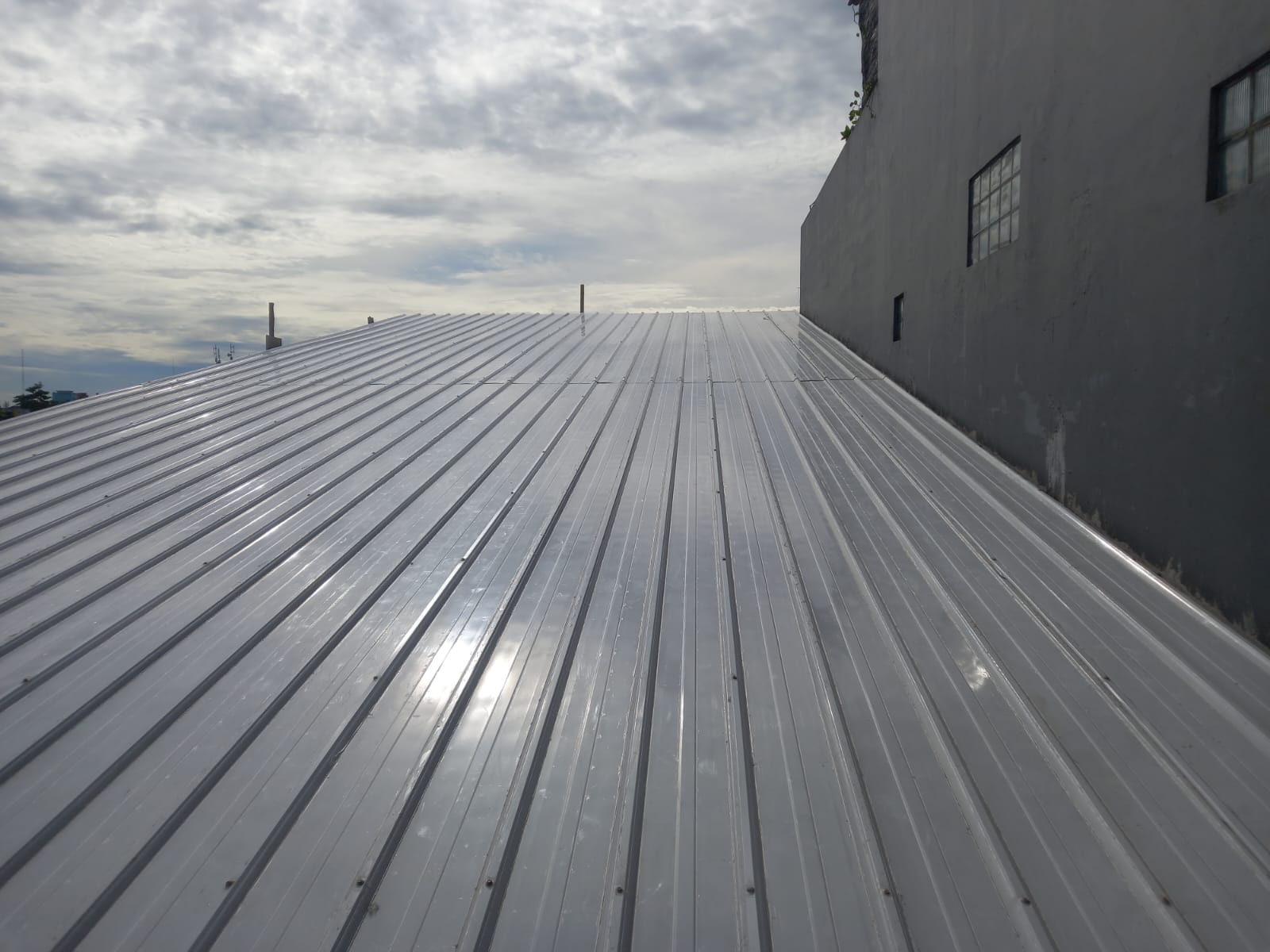 Installed metal insulated standing-seam roof on a completed industrial building